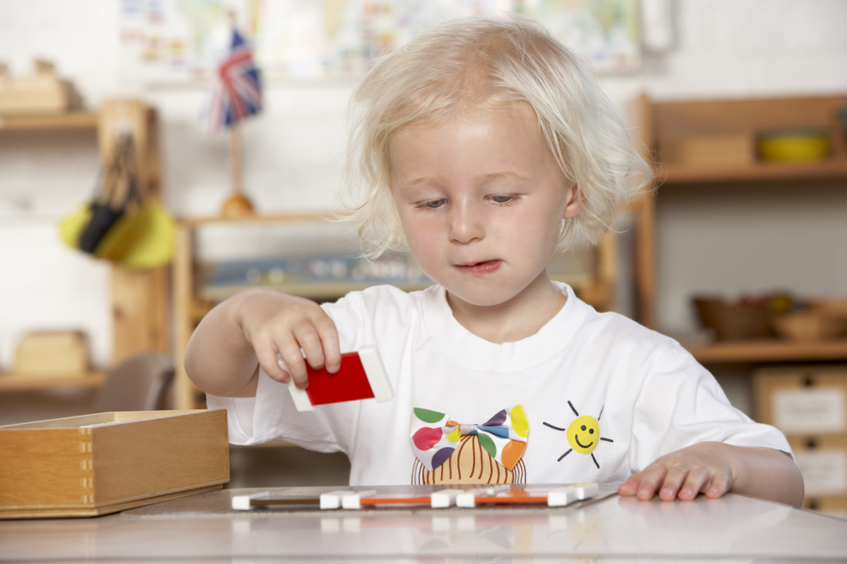 A Children’s House student working with Montessori color block materials