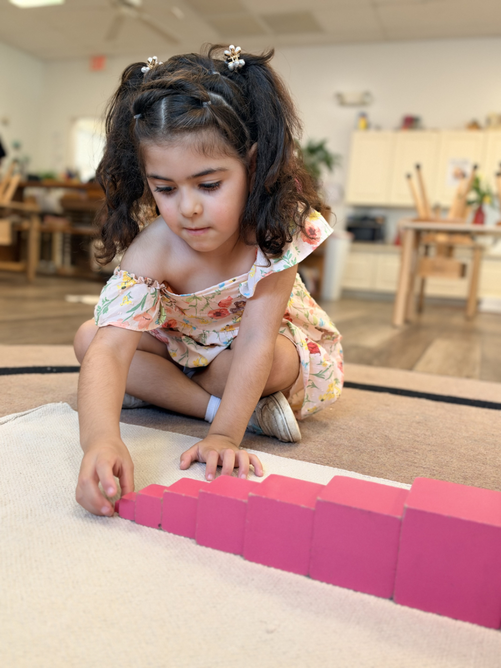 A Children’s House student working with Montessori color block materials